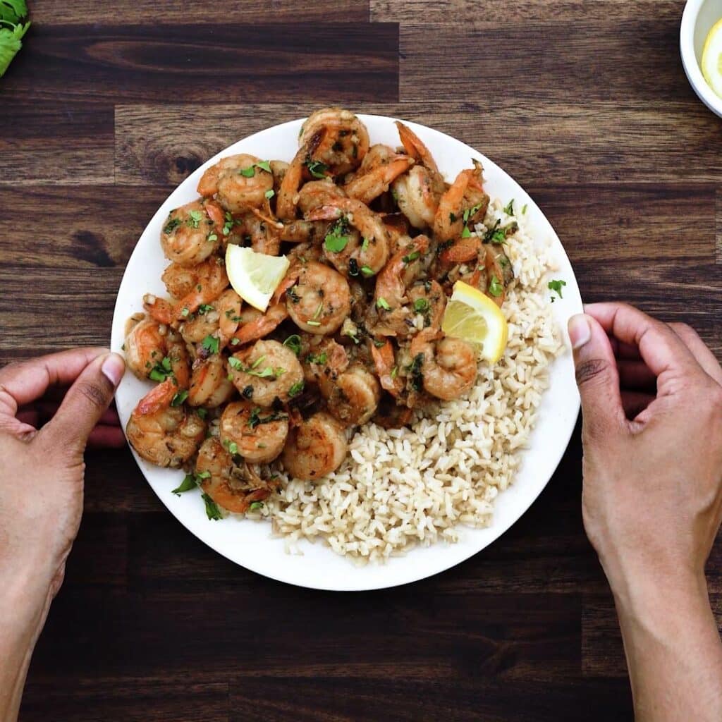 Serving Sautéed Shrimp over brown rice.