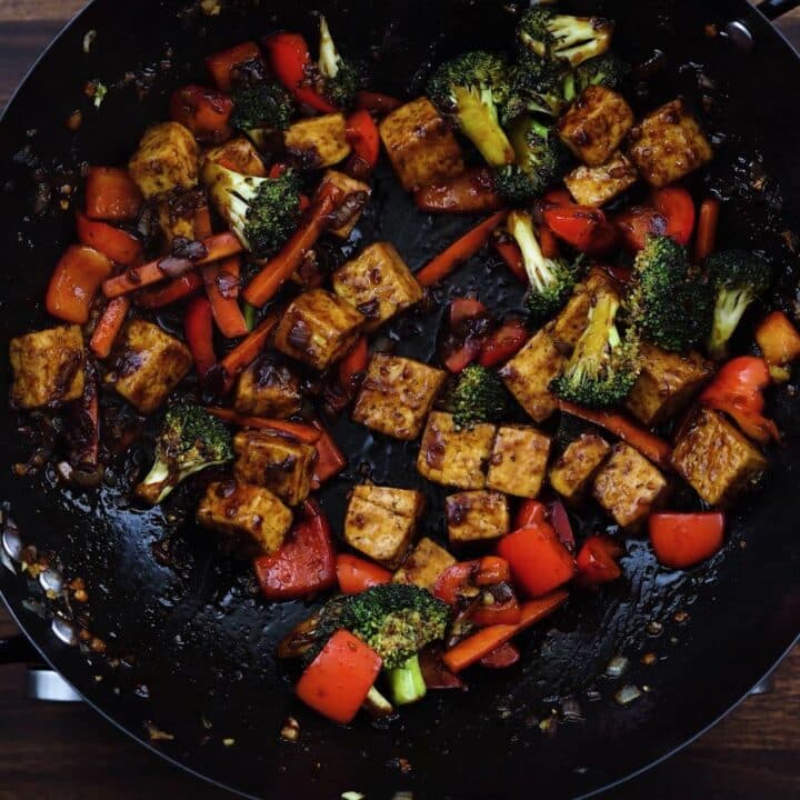 Stir fried tofu in a wok.