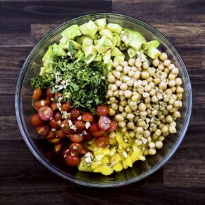 A bowl with Chickpea Salad dressed with a tangy dressing.