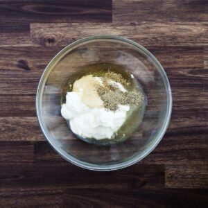 A bowl with coleslaw dressing ingredients.