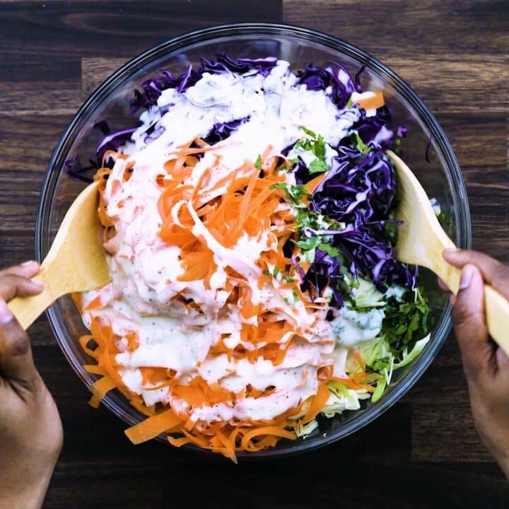 Tossing the veggies in a creamy coleslaw dressing.