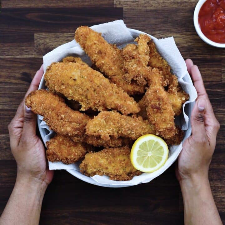 Serving the Fried Chicken Tenders in a serving bowl with lemon slice.