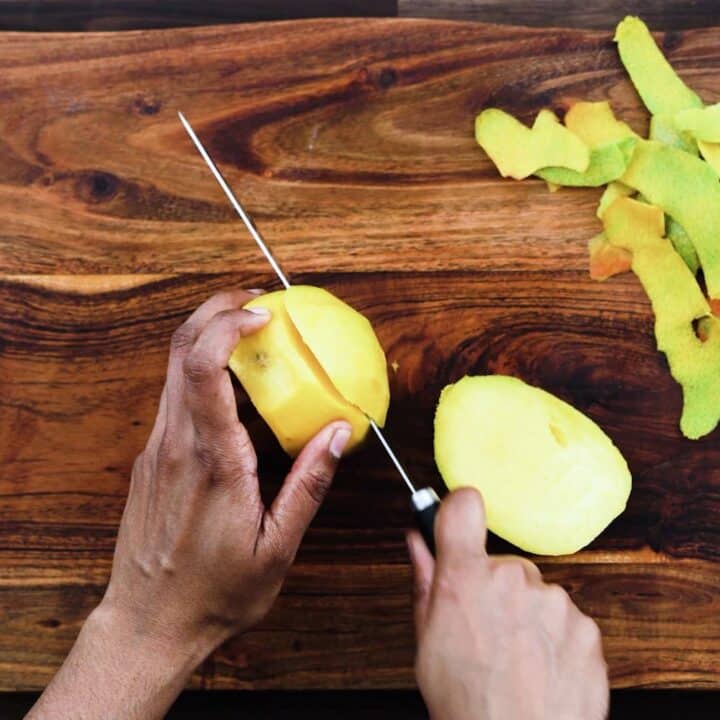 Slicing the mango pulp using knife.
