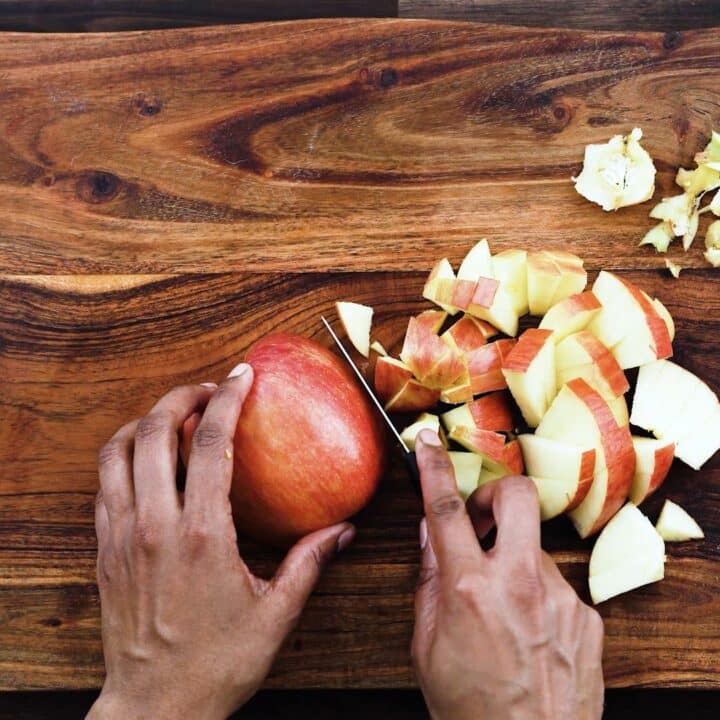 Dicing the apples using a knife.