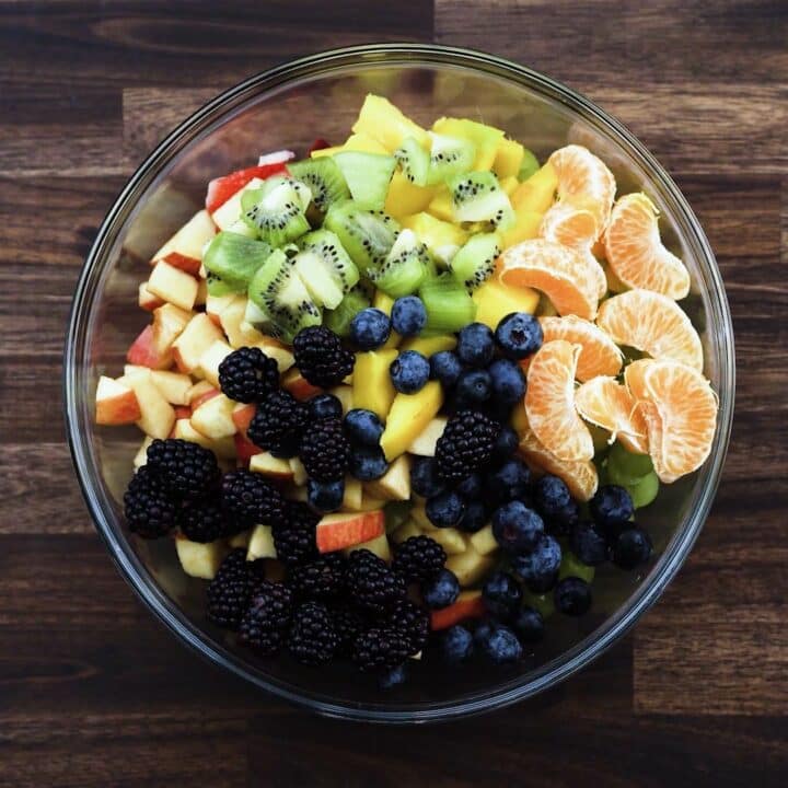 A bowl with chopped fruits.