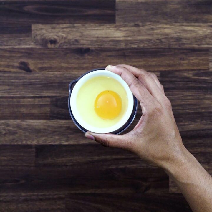 Adding egg to thee tall jar.