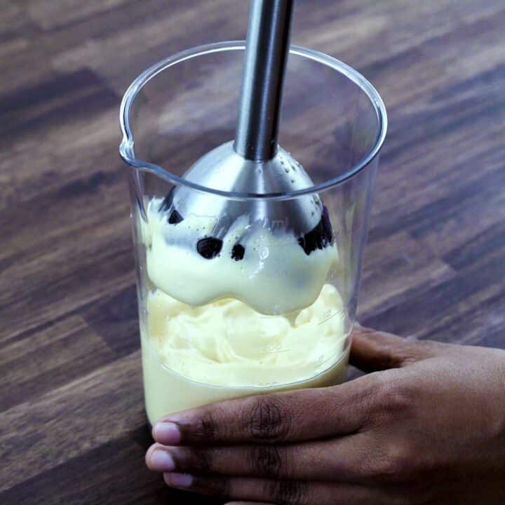 Fluffy and creamy mayonnaise in immersion blender jar.