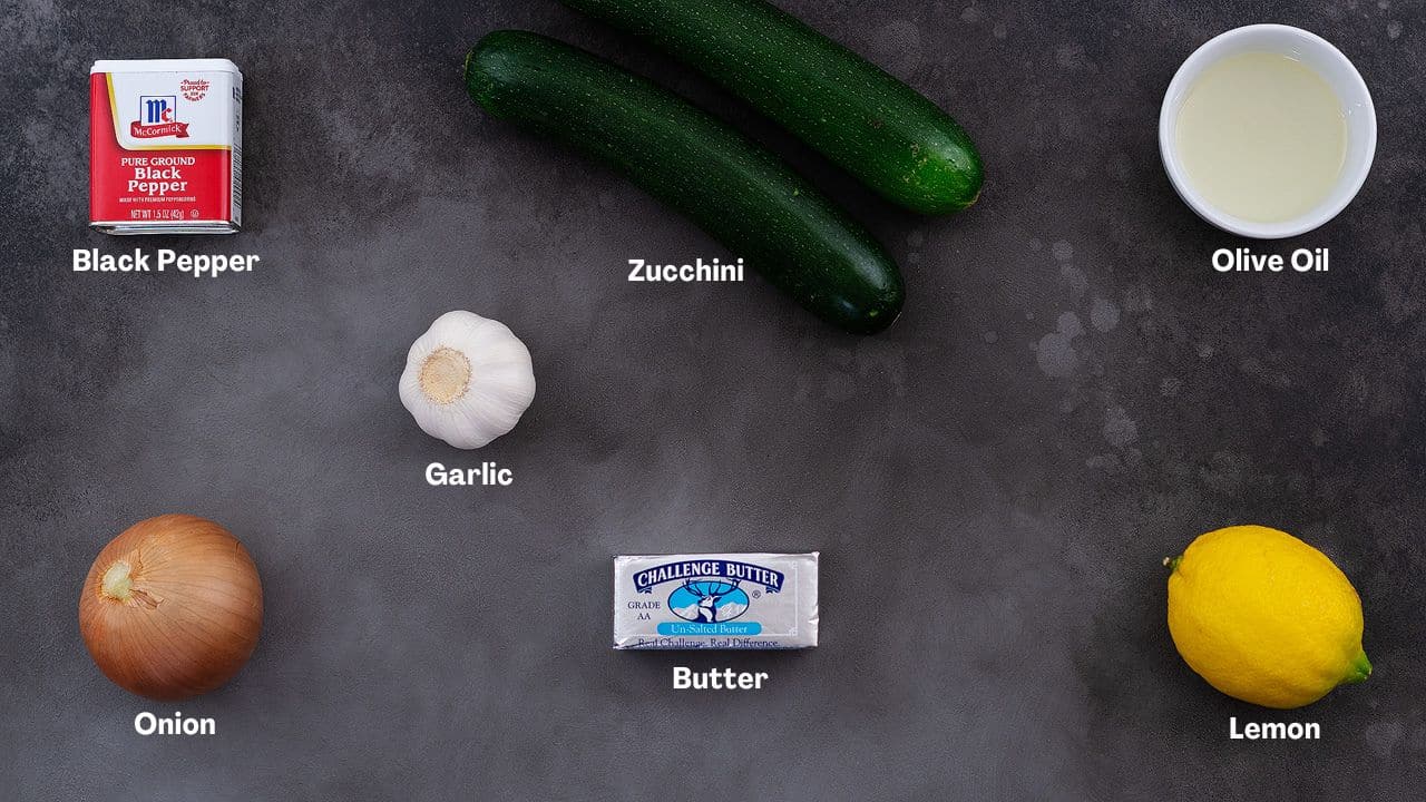Sauteed Zucchini recipe Ingredients arranged on a grey table.