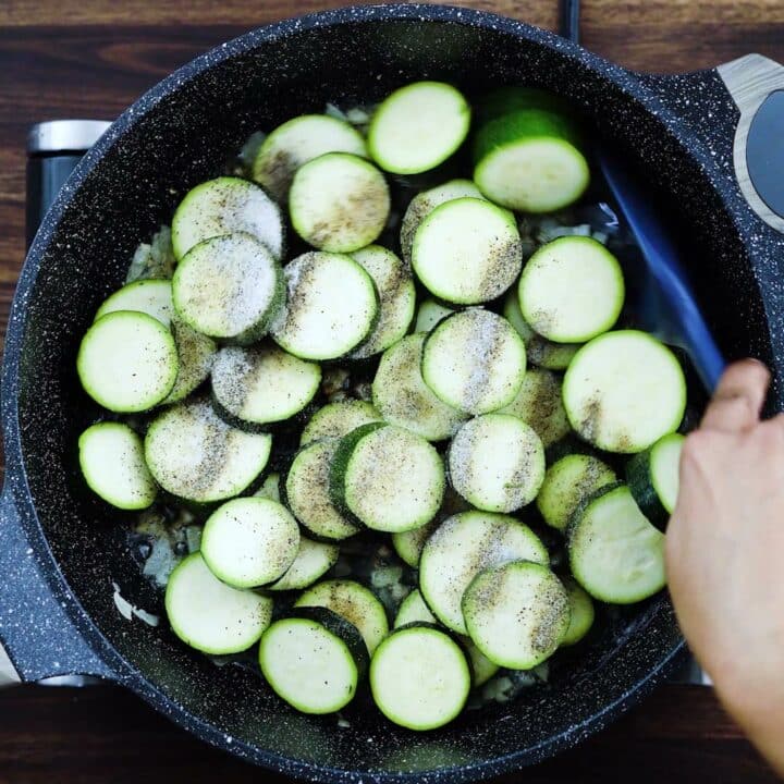 Sauteing the zucchini with seasoning.