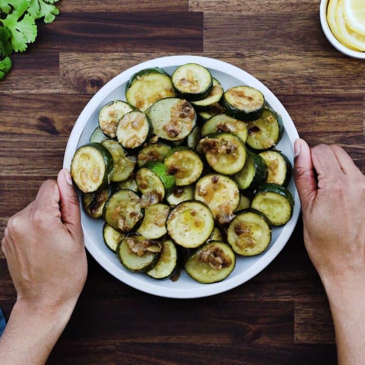 Serving Sauteed Zucchini in a white plate.