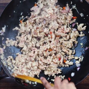 Sauteing the chicken in high heat wok.