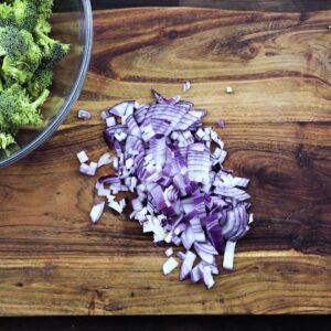 Chopped onions on a cutting board.
