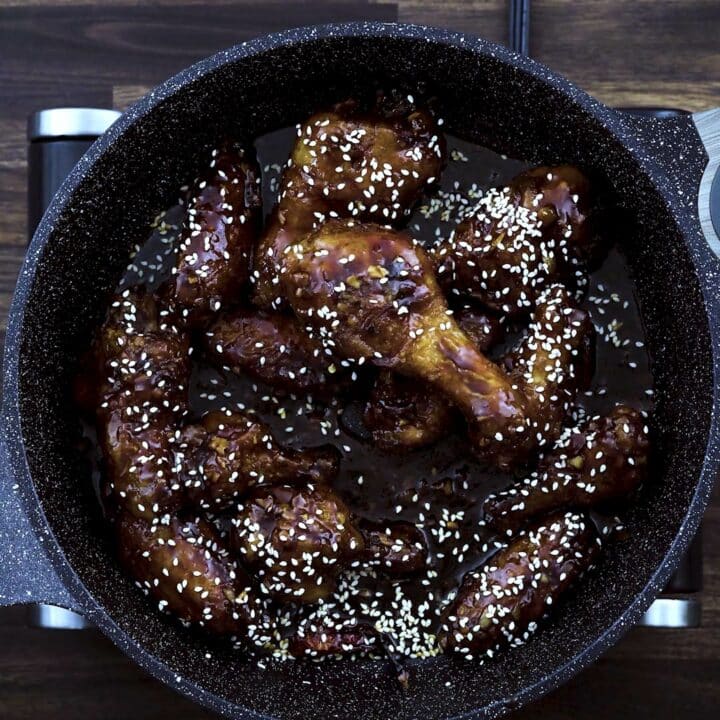 Double fried Korean chicken garnished with sesame oil.