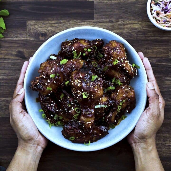 Serving the Korean Fried Chicken in a blue bowl.
