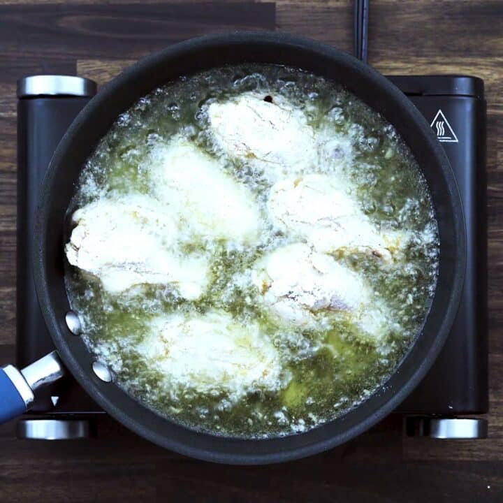 Frying the chicken wings in hot oil.