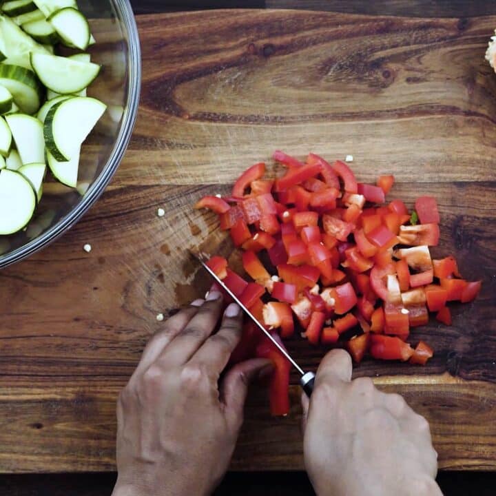 Dicing the bell peppers using a knife.
