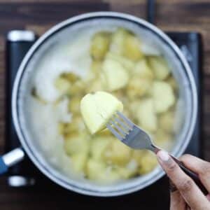 Showing fork tender boiled potatoes.