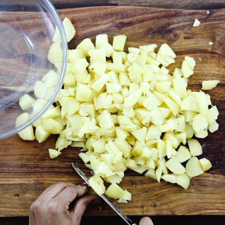 Dicing the boiled potatoes with knife.