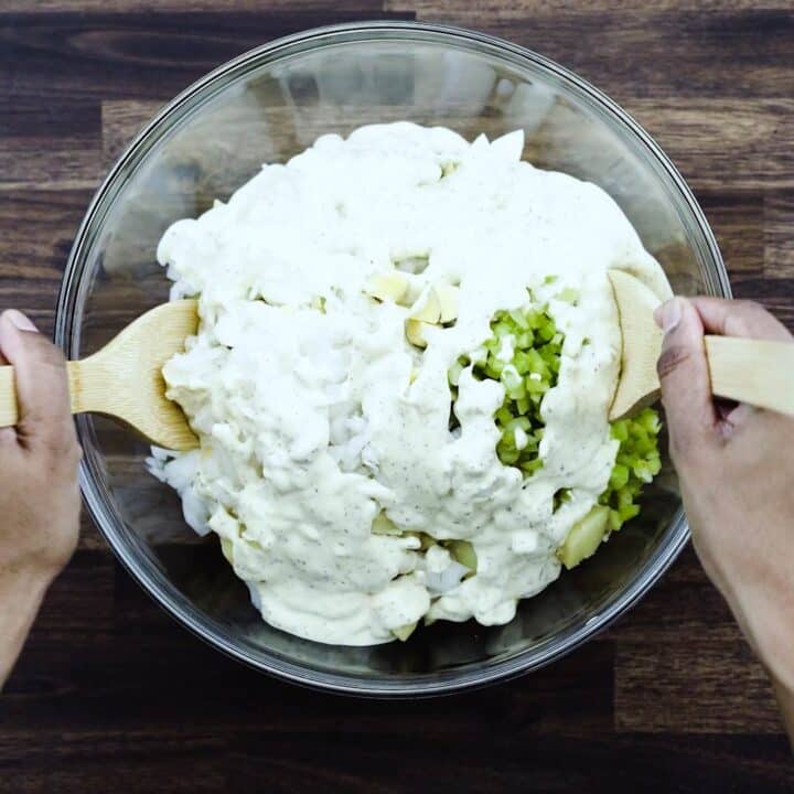 Mixing the Potato Salad mixture with creamy dressing.