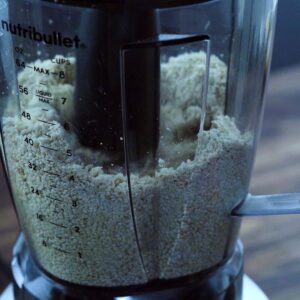 Processing the sesame seeds using a tamper in the blender.
