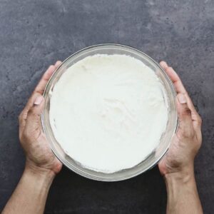 A bowl with Caesar Salad Dressing.