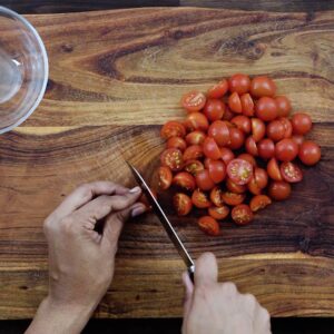Halving the cherry tomatoes.