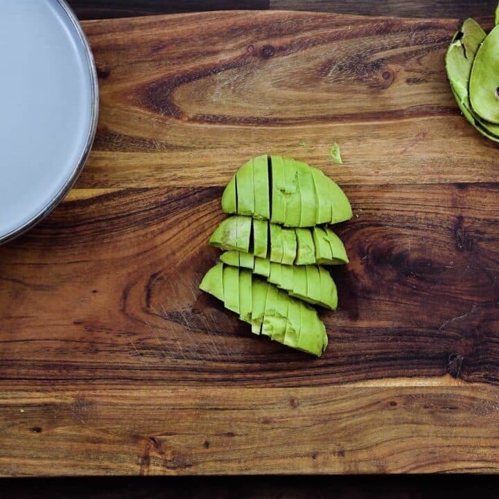 Sliced avocado on a cutting board.