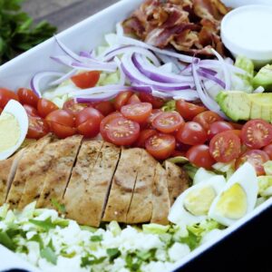 A closeup view of cobb salad in a tray.