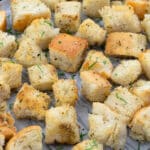 Close up of homemade croutons on a baking tray.