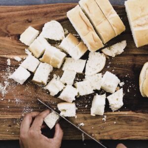 Slicing the bread into bite size cubes.
