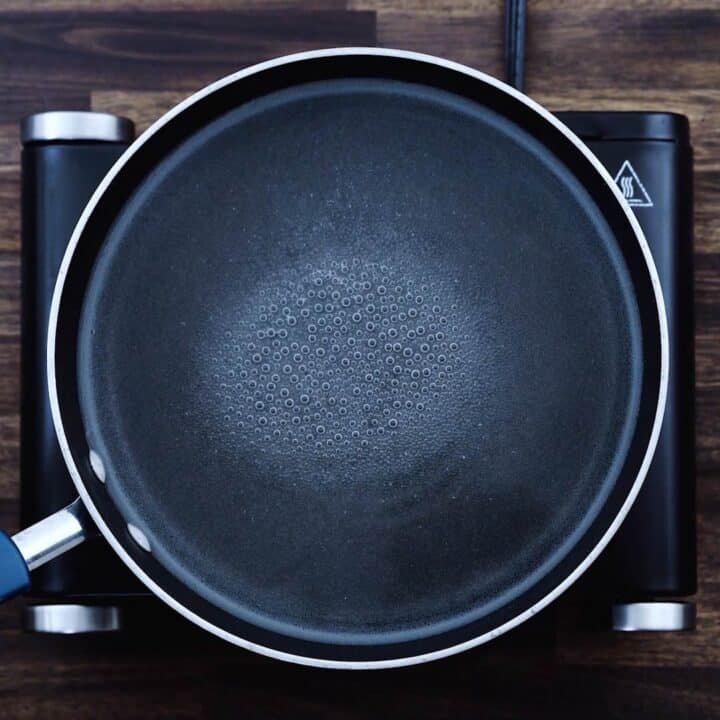 A wide pot or pan with simmering water.