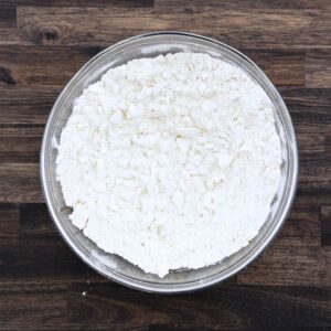 A bowl with Hush Puppy mixture flour and onions