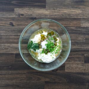 A bowl with salad dressing ingredients.