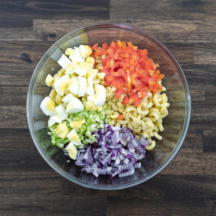 A bowl with Macaroni Salad ingredients.