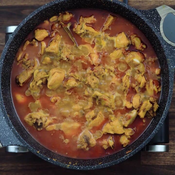 Simmering chicken masala in a pan.