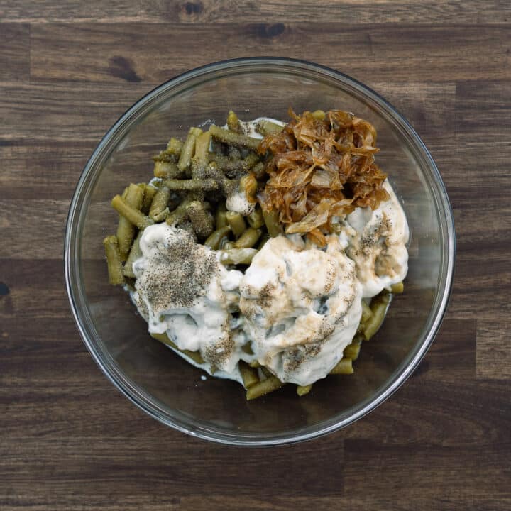 A bowl with green bean casserole ingredients.