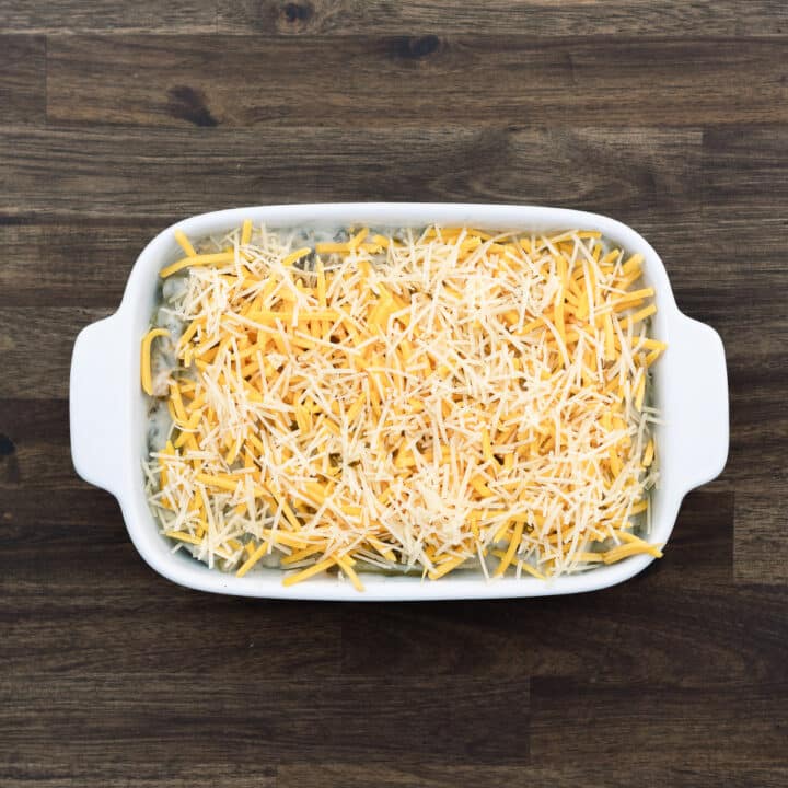 Green Bean Casserole mixture topped with cheddar and parmesan cheese.