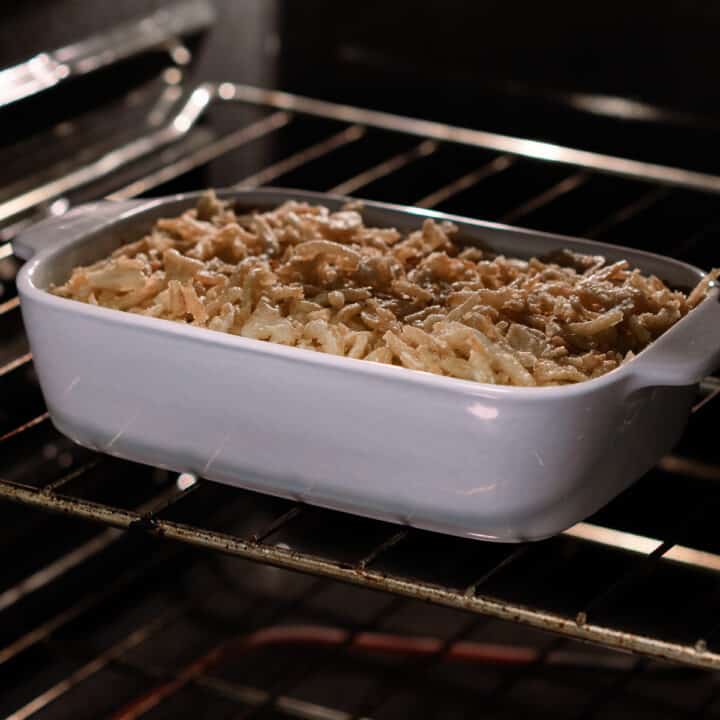 Green Bean Casserole mixture with fried onions baking inside the oven.