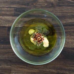 A bowl with salad dressing ingredients.