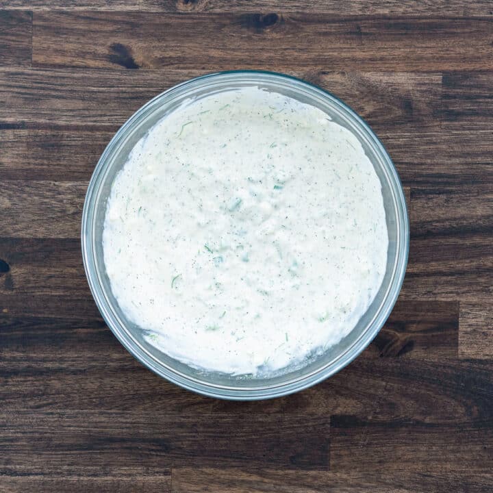 A bowl with creamy salad dressing.