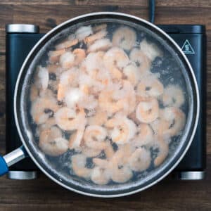 A pan with shrimp in a hot a water.