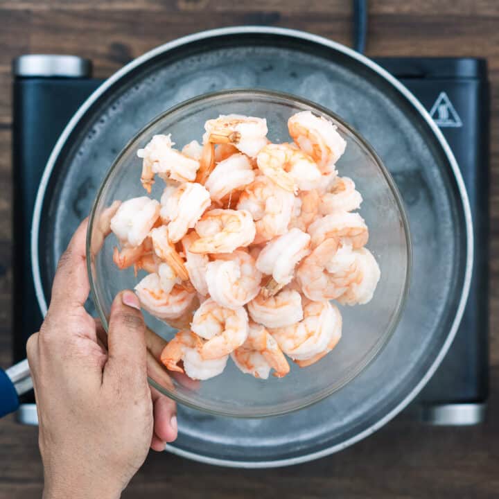A bowl with cooked shrimp.