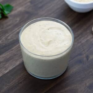 Tahini dressing served in a glass jar.