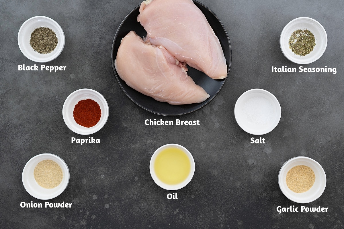 Ingredients for chicken and rice casserole, including black pepper powder, chicken breast, Italian seasoning, paprika, salt, onion powder, oil, and garlic powder.