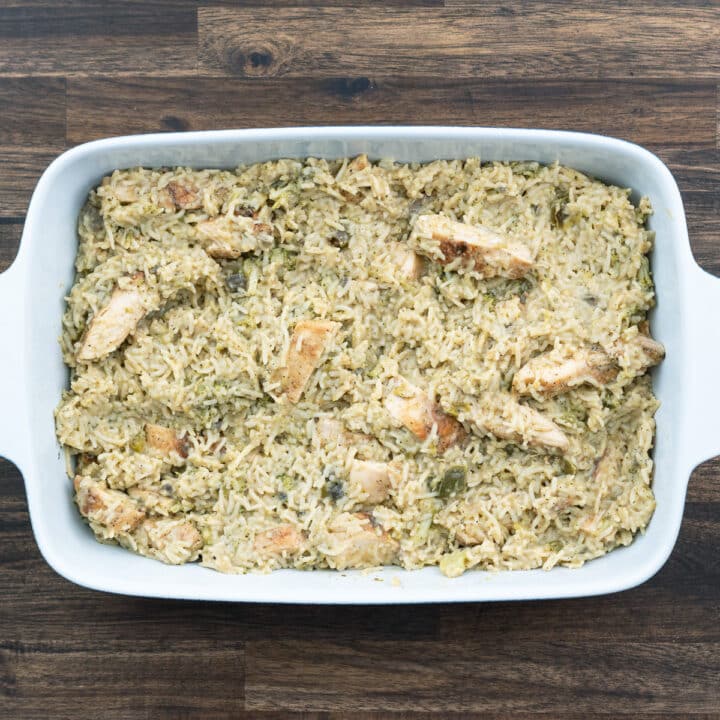 A baking dish with rice and chicken casserole mix.