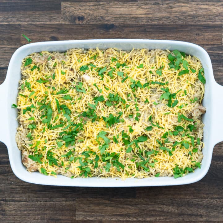 Casserole mix topped with cheese and parsley leaves.