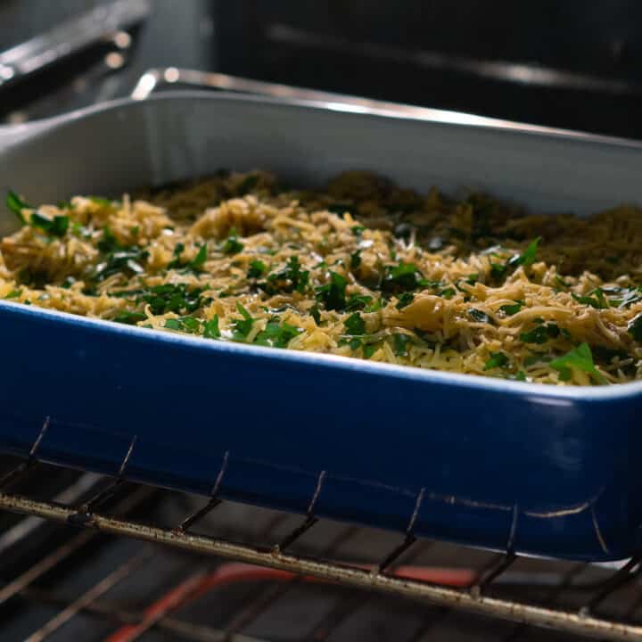 Chicken and rice casserole mix being baked inside oven.