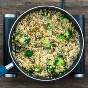 A pan with rice and veggie mixture.