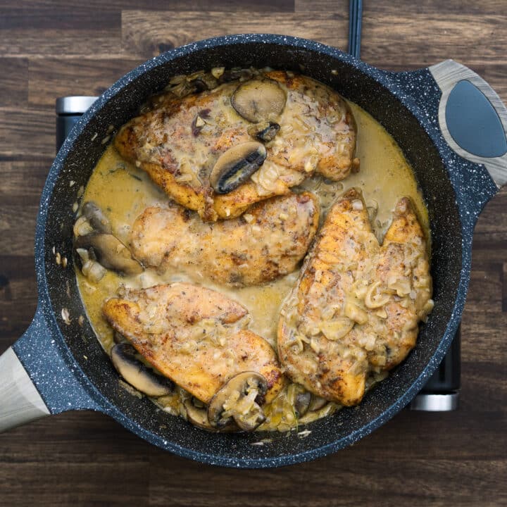 A pan with chicken breast ina creamy marsala wine sauce.