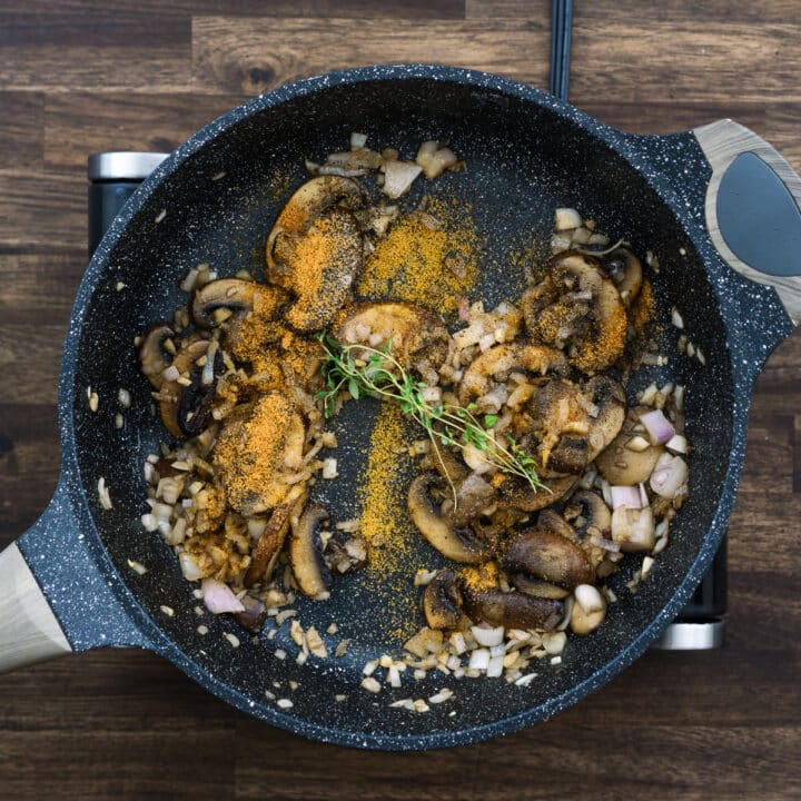 A pan with sauteed mushrooms, garlic, onion and basic seasonings.